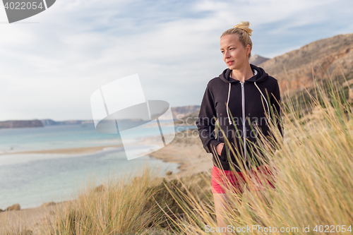 Image of Relaxed Happy Woman Enjoying Walk on Beach