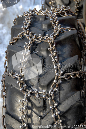 Image of Spike chain on tractor wheel