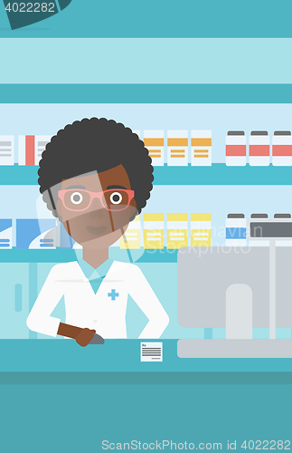 Image of Pharmacist at counter with computer monitor.