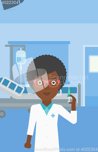 Image of Doctor with syringe in hospital ward.