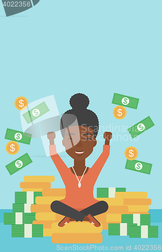 Image of Happy business woman sitting on coins.