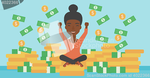 Image of Happy business woman sitting on coins.