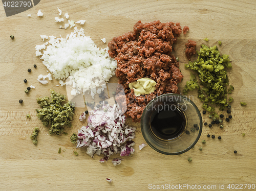 Image of mixing steak tartare ingredients in a bowl