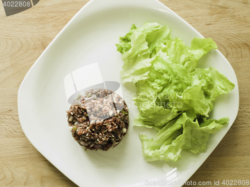 Image of mixing steak tartare ingredients in a bowl