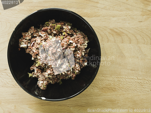 Image of mixing steak tartare ingredients in a bowl
