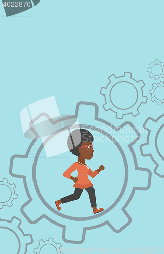 Image of Business woman running inside the gear.