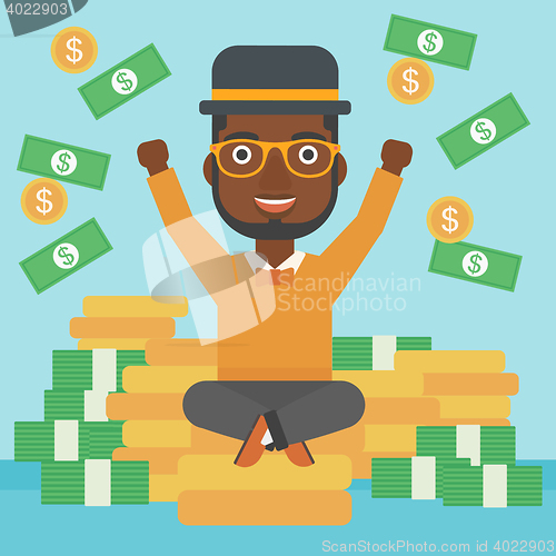 Image of Happy businessman sitting on coins.