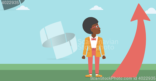 Image of Business woman looking at arrow going up.