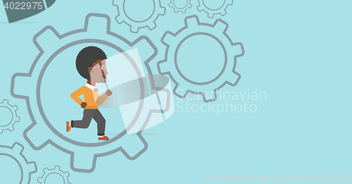 Image of Businessman running inside the gear.