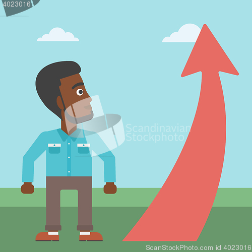 Image of Businessman looking at arrow going up.