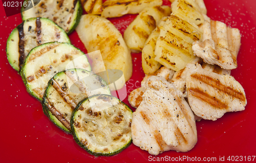 Image of Grilled dinner on the red plate