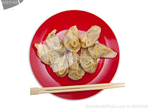 Image of Dumplings on the red plate isolated on the white background