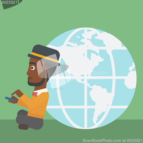 Image of Businessman sitting near Earth globe.