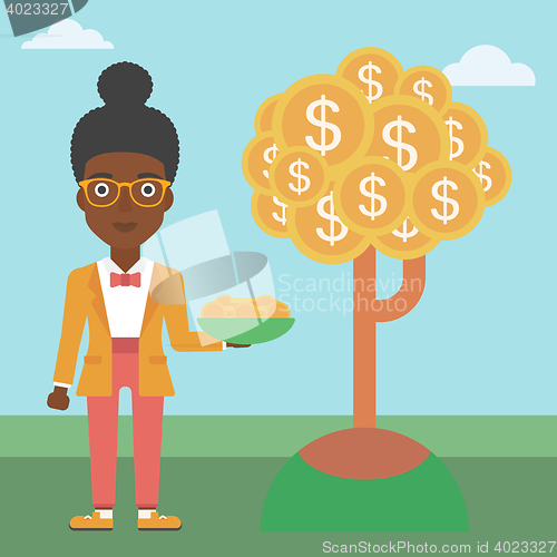 Image of Business woman catching dollar coins.