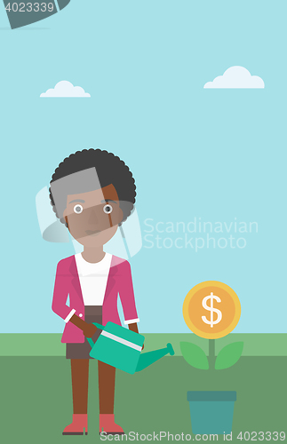 Image of Business woman watering money flower.