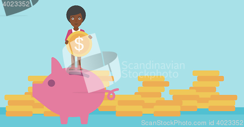 Image of Business woman putting coin in piggy bank.