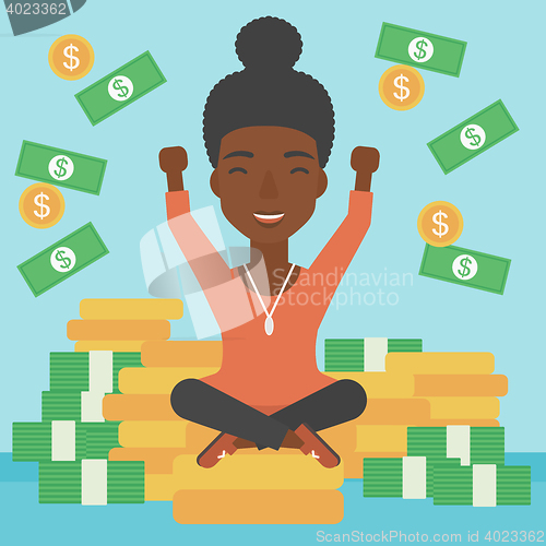 Image of Happy business woman sitting on coins.