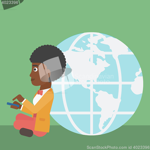 Image of Businessman sitting near Earth globe.