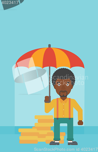 Image of Businessman with umbrella protecting money.