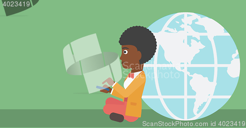 Image of Businessman sitting near Earth globe.