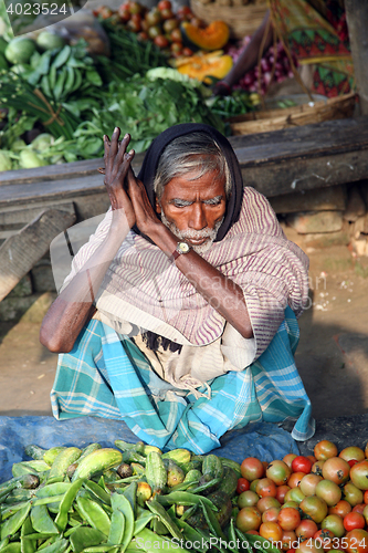 Image of Tribal villagers bargain for vegetables. Sonakhali, West Bengal, India