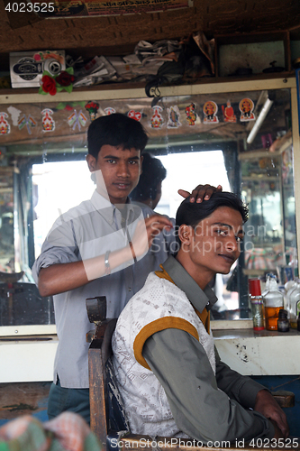 Image of Hair cutting in an indian's salon in Sonakhali, West Bengal, India