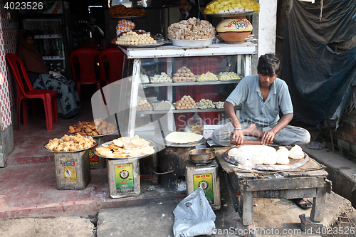 Image of Vendor sits in lotus position, Sonakhali, West Bengal, India