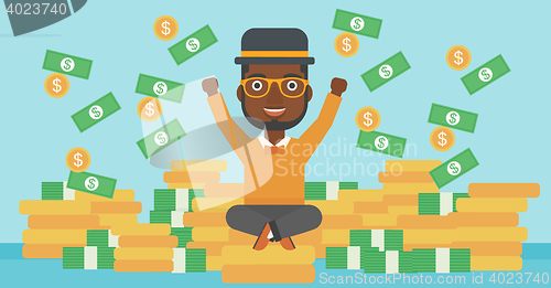 Image of Happy businessman sitting on coins.