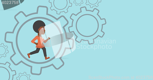 Image of Business woman running inside the gear.