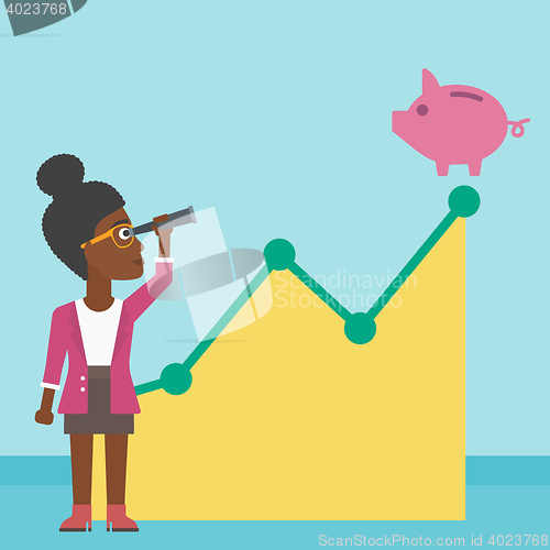 Image of Business woman looking at piggy bank.