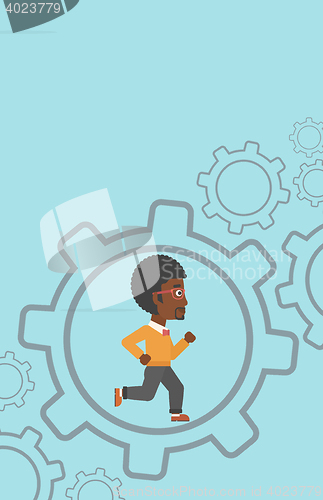 Image of Businessman running inside the gear.