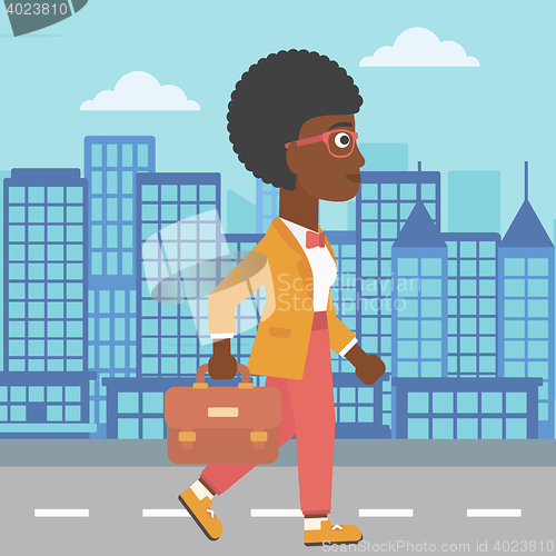 Image of Successful business woman walking with briefcase.