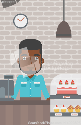 Image of Worker standing behind the counter at the bakery.