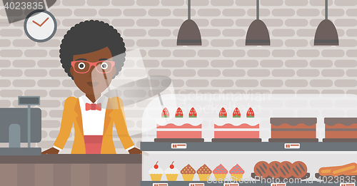 Image of Worker standing behind the counter at the bakery.