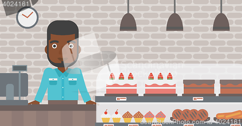 Image of Worker standing behind the counter at the bakery.