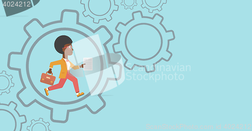 Image of Business woman running inside the gear.