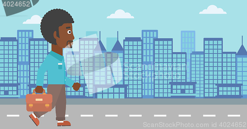 Image of Successful businessman walking with briefcase.