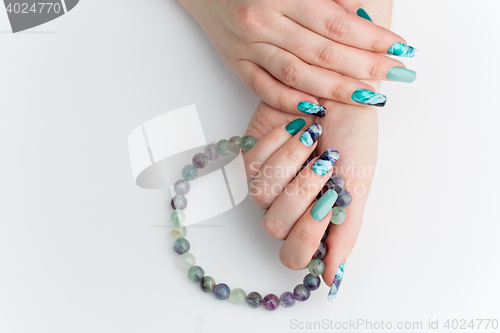 Image of Closeup of woman hands with colorful nails