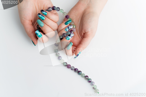 Image of Closeup of woman hands with colorful nails