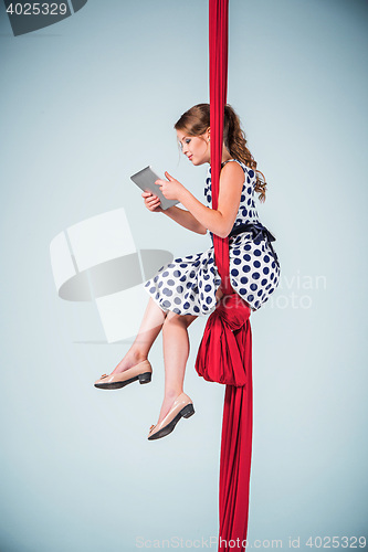 Image of Graceful gymnast sitting with laptop