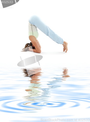 Image of salamba sirsasana supported headstand on white sand #4