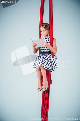 Image of Graceful gymnast sitting with laptop