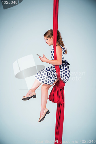 Image of Graceful gymnast sitting with laptop