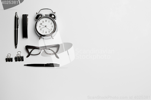 Image of The clock, pen, and glasses on white background