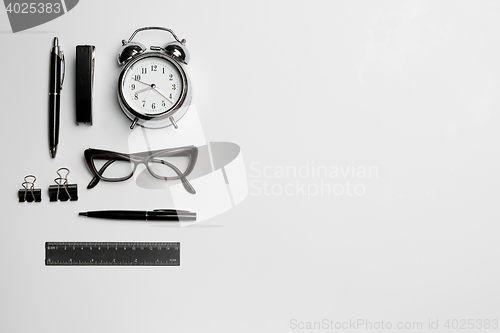 Image of The clock, pen, and glasses on white background