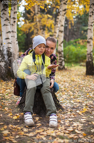 Image of Woman and her son with camera