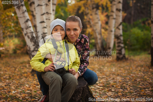 Image of Woman and her son with camera