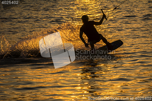 Image of Silhouette Wakeboarder in action on sunset