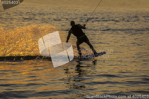 Image of Silhouette Wakeboarder in action on sunset