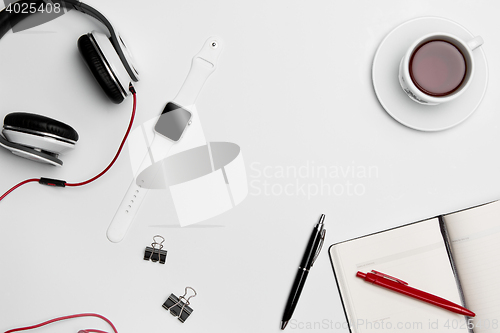Image of The cup, pen, and headphones on white background